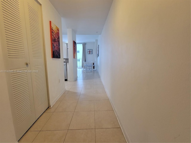 hall with light tile patterned floors