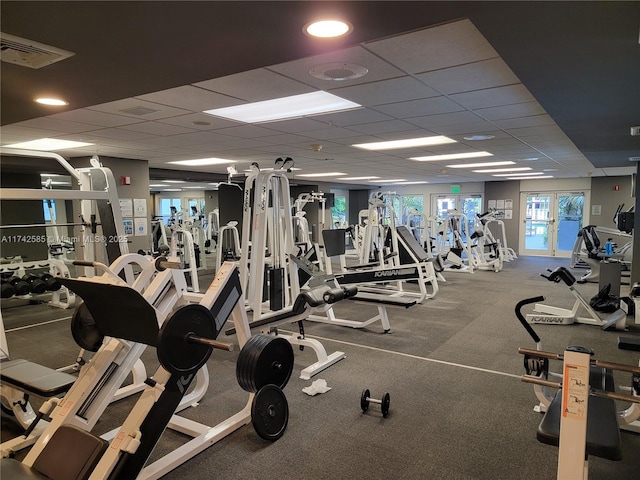 gym with a paneled ceiling