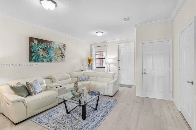 living room with ornamental molding and light hardwood / wood-style flooring