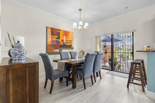 dining area with crown molding, an inviting chandelier, and light hardwood / wood-style floors