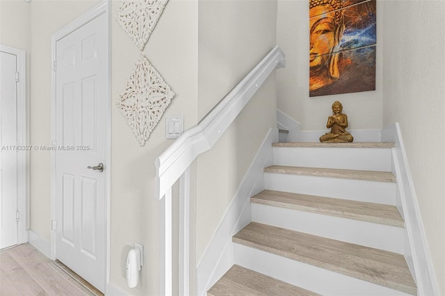 stairs with wood-type flooring