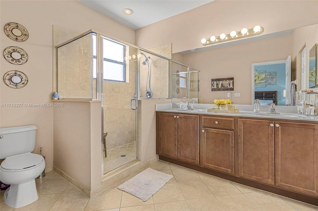 bathroom with vanity, tile patterned floors, toilet, and walk in shower