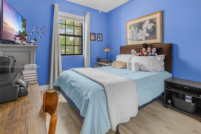 bedroom with hardwood / wood-style floors