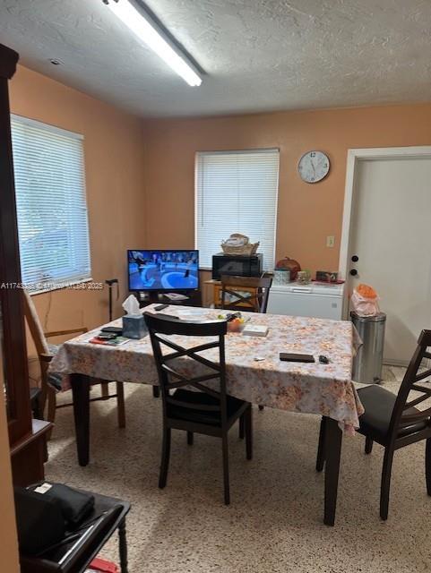 dining space with a textured ceiling