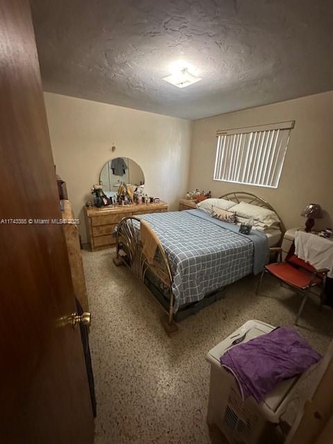 bedroom featuring a textured ceiling