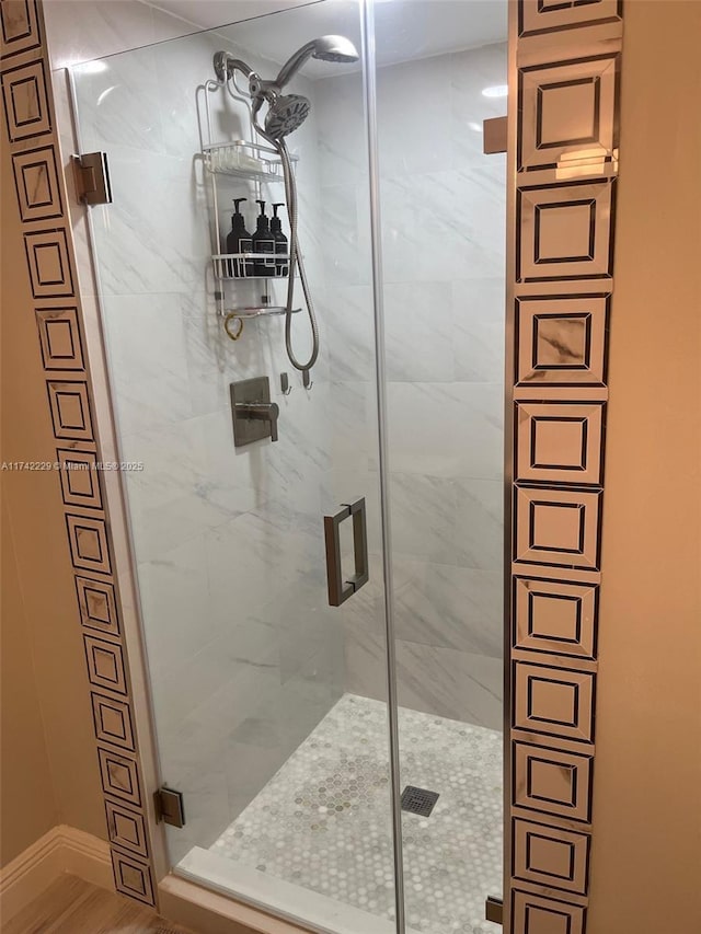 bathroom featuring a shower with shower door