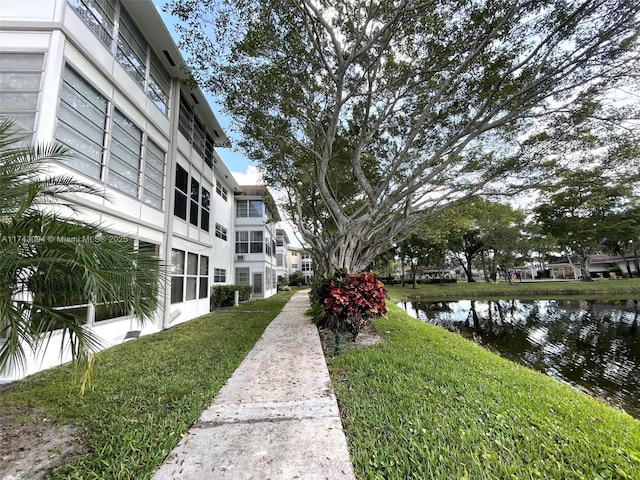 5102 NW 36th St Unit 611, Lauderdale Lakes, FL 33319 - view of community with a water view and a yard