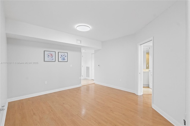 spare room featuring light hardwood / wood-style flooring