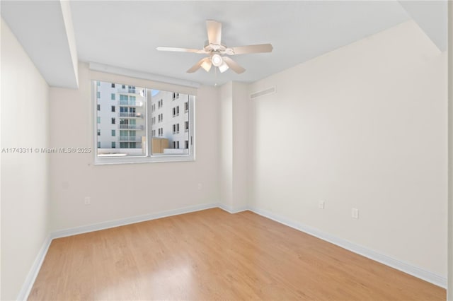 spare room featuring light hardwood / wood-style floors and ceiling fan