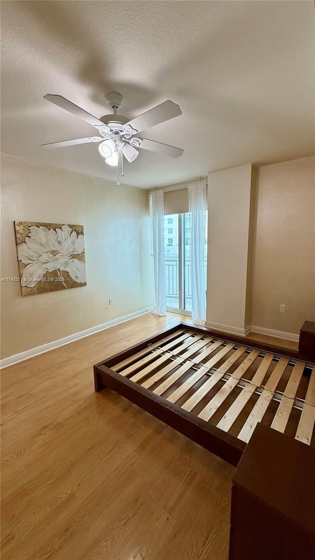 unfurnished bedroom with ceiling fan, light hardwood / wood-style floors, and a textured ceiling