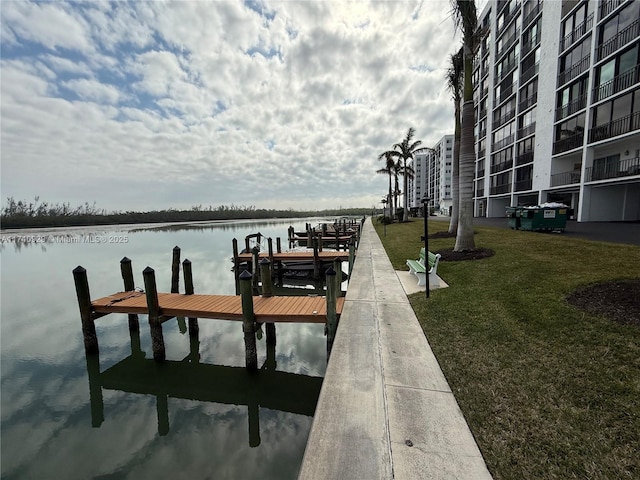 dock area with a yard and a water view