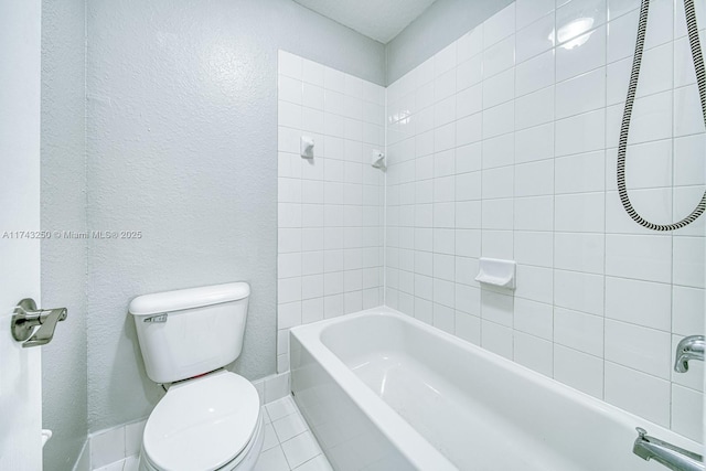 bathroom with tiled shower / bath and toilet