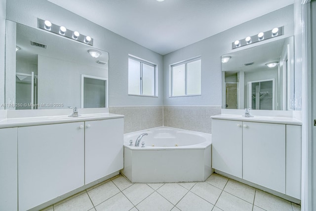 bathroom featuring vanity, plus walk in shower, and tile patterned flooring