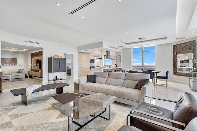 living room featuring a raised ceiling