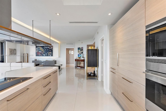 kitchen with appliances with stainless steel finishes, light brown cabinetry, and light tile patterned floors