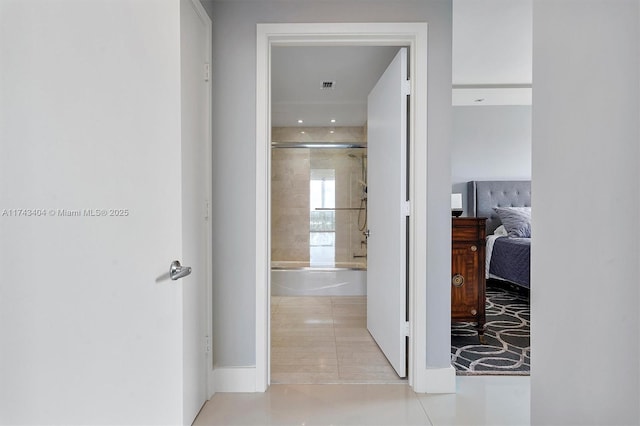 corridor with light tile patterned floors