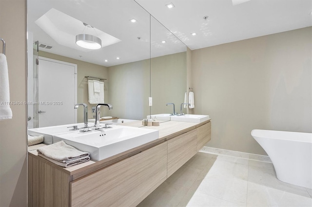 bathroom featuring tile patterned flooring, vanity, and a bathtub