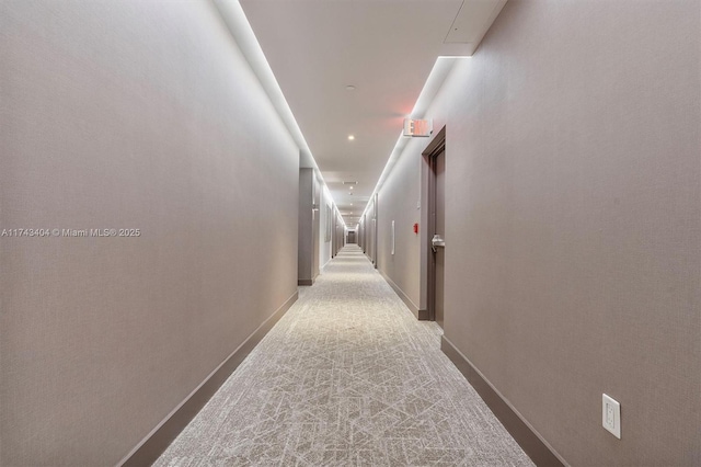 hall with light colored carpet