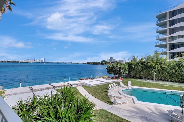 view of pool featuring a water view and a patio area