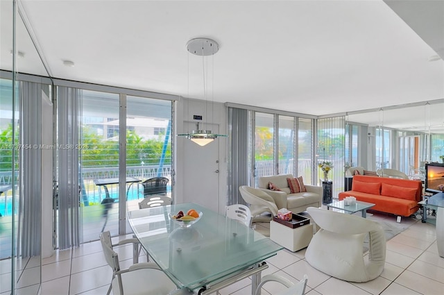 1155 103rd St Unit 9B, Bay Harbor Islands, FL 33154 - dining area with light tile patterned floors and a wall of windows