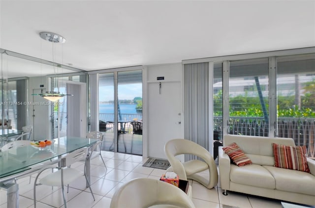 tiled living room with expansive windows and a water view