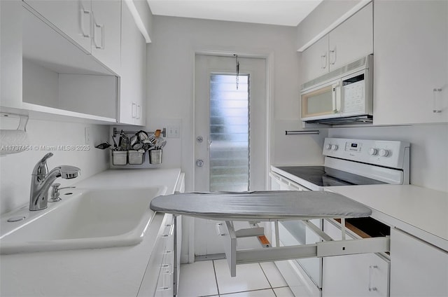 kitchen with white cabinetry, sink, and white appliances