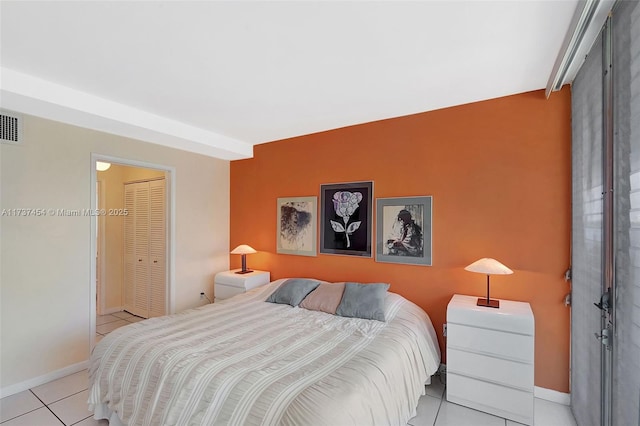 bedroom featuring light tile patterned floors and a closet