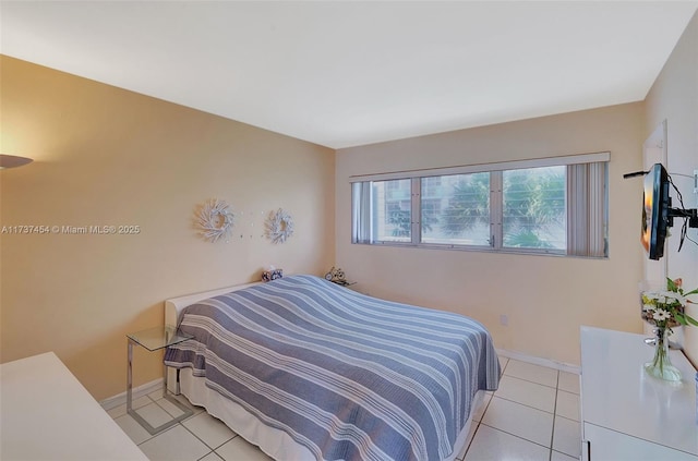 1155 103rd St Unit 9B, Bay Harbor Islands, FL 33154 - bedroom featuring light tile patterned floors and baseboards