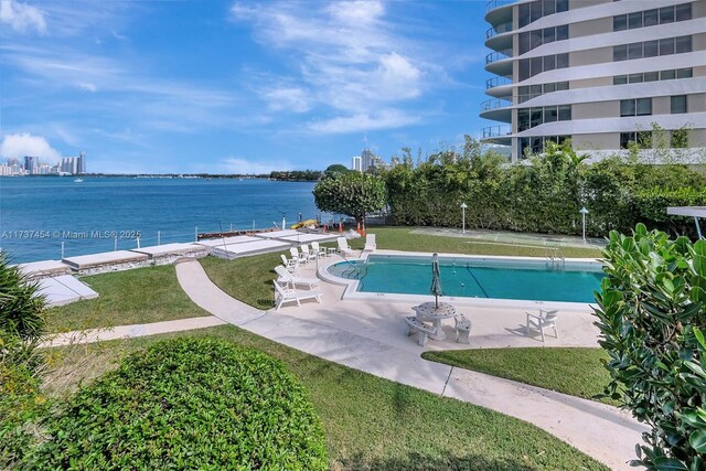 1155 103rd St Unit 9B, Bay Harbor Islands, FL 33154 - community pool with a lawn, a patio, and a water view