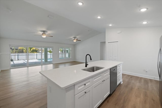 kitchen with sink, a center island with sink, stainless steel dishwasher, hardwood / wood-style floors, and white cabinets