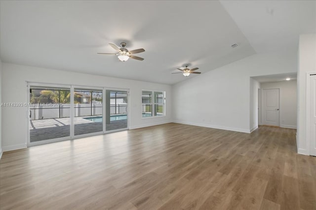 unfurnished room with lofted ceiling, ceiling fan, and light hardwood / wood-style flooring