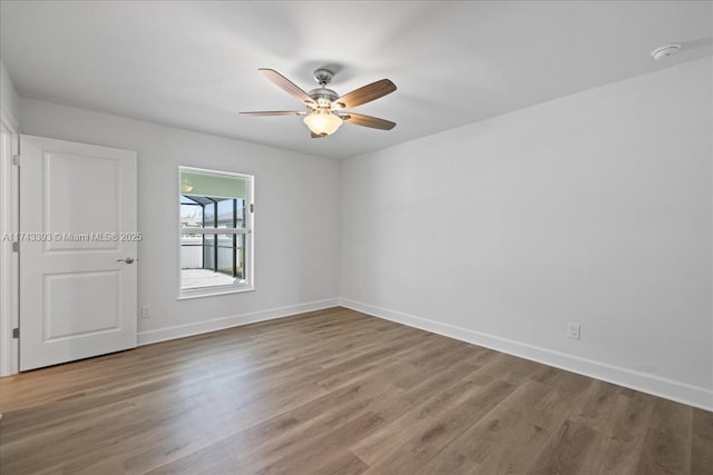 spare room featuring hardwood / wood-style flooring and ceiling fan