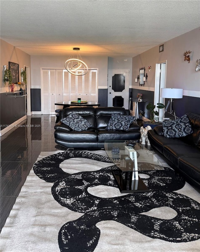 living room with a chandelier and a textured ceiling