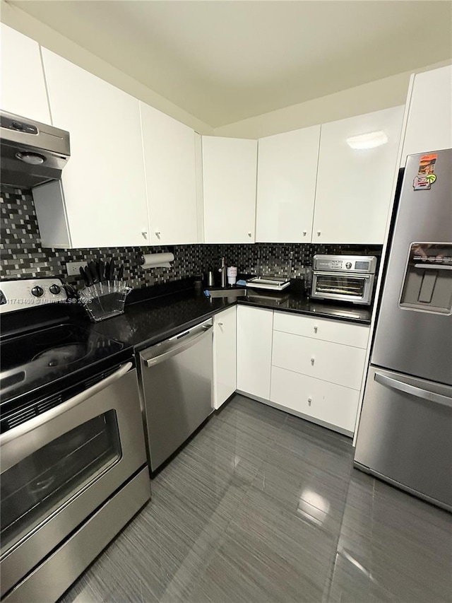 kitchen featuring backsplash, appliances with stainless steel finishes, exhaust hood, and white cabinets