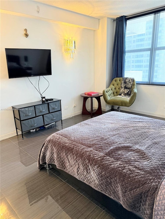 bedroom featuring dark tile patterned flooring