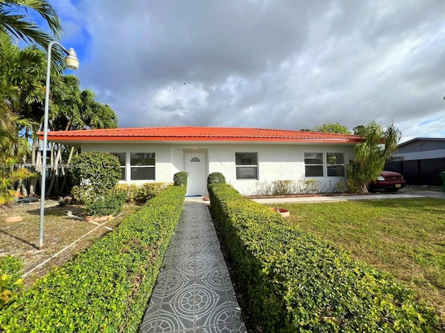 ranch-style home with a front lawn