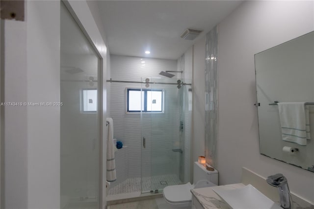 bathroom with vanity, toilet, and an enclosed shower