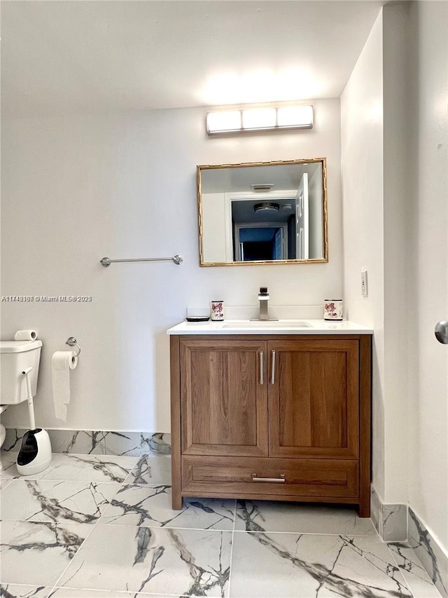 bathroom featuring vanity and toilet