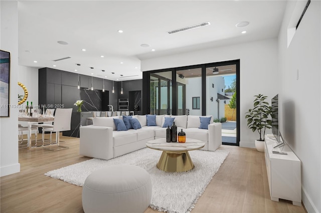 living room with light hardwood / wood-style flooring