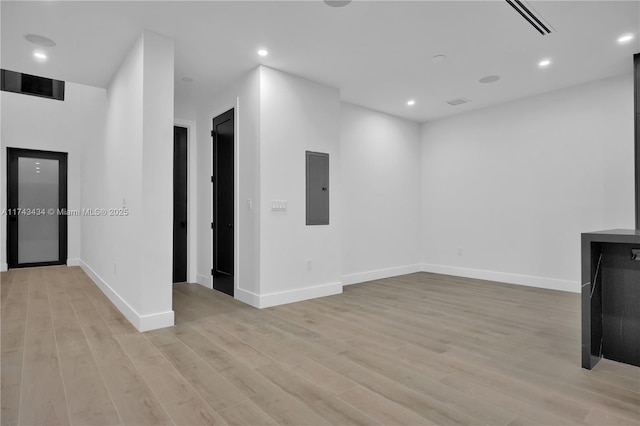 unfurnished living room featuring light hardwood / wood-style floors and electric panel