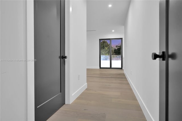 corridor with light hardwood / wood-style flooring