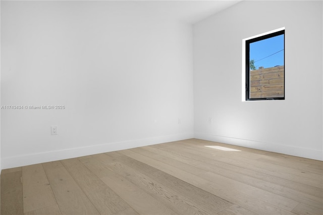 empty room with light hardwood / wood-style flooring