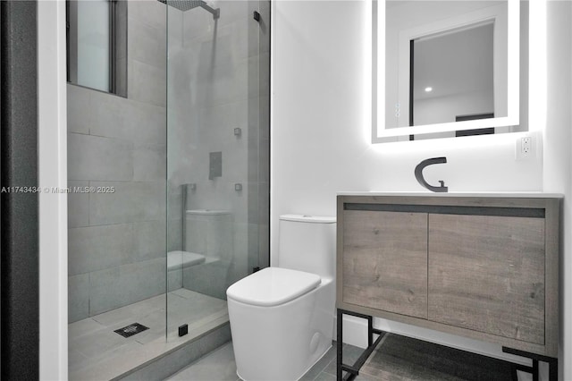 bathroom with vanity, toilet, and tiled shower