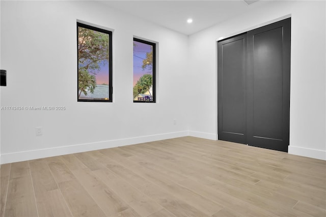 spare room featuring light wood-type flooring