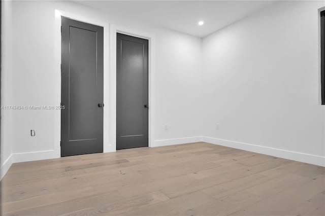 unfurnished bedroom featuring light hardwood / wood-style floors and a closet