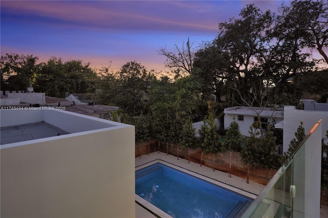 view of pool at dusk