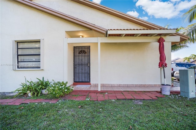 entrance to property featuring a yard