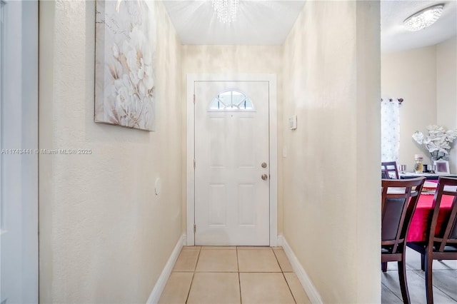 doorway to outside with light tile patterned floors