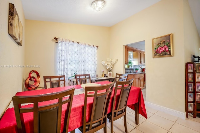 dining space with sink and light tile patterned floors