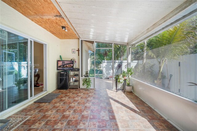 unfurnished sunroom with wooden ceiling